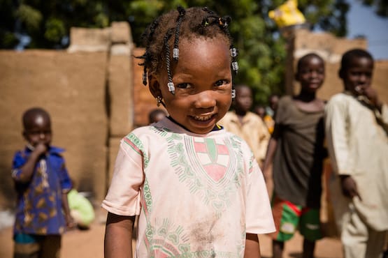 Little girl in pink dress smiling